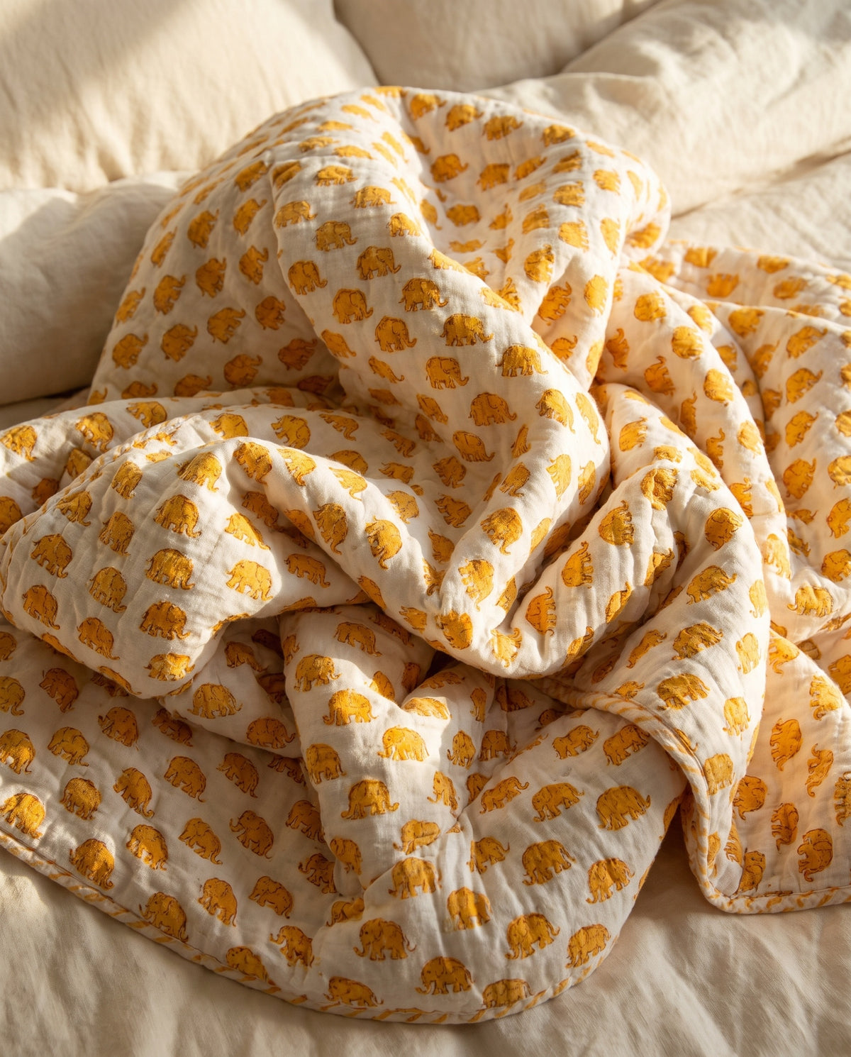 Elephant Wishes reversible cotton baby blanket, side two, bed editorial
