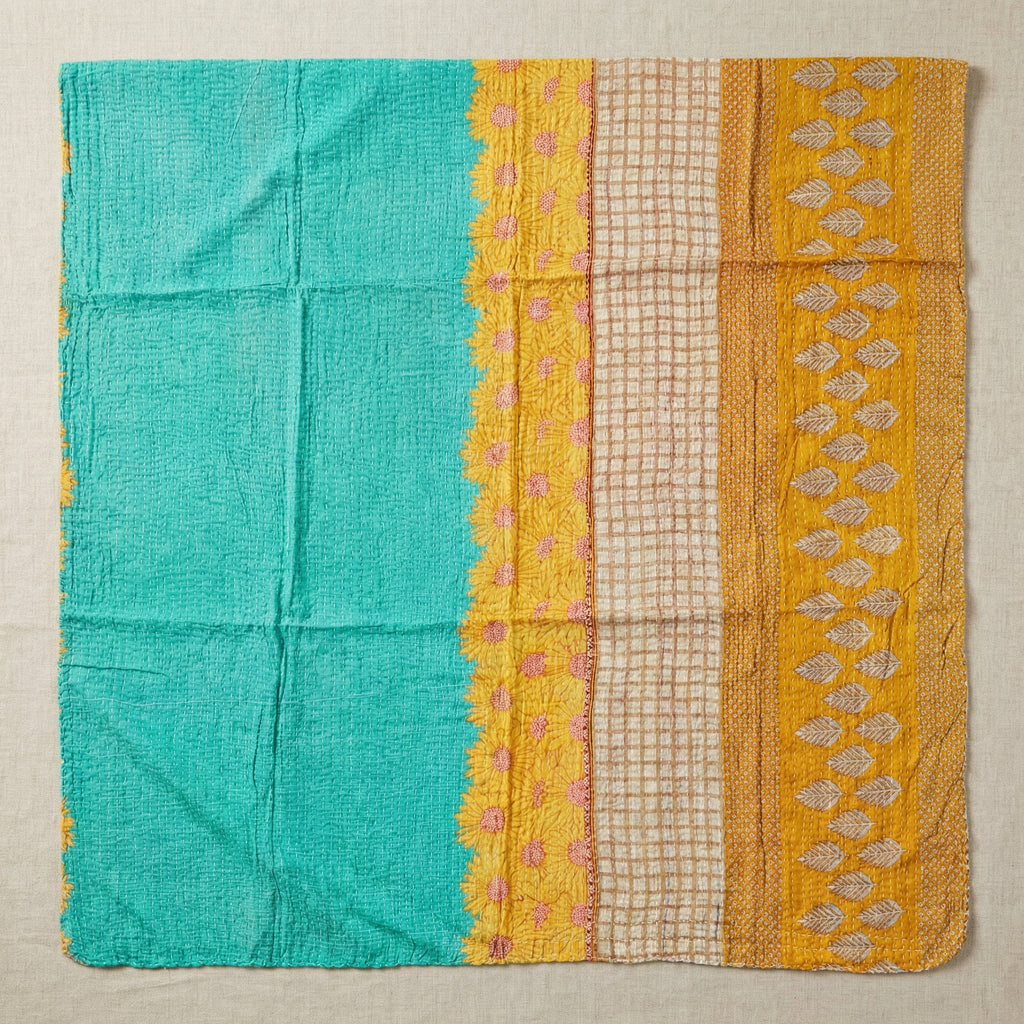 Textile with turquoise, yellow, and beige patterns on a beige background