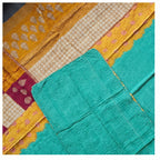 Close-up of a colorful fabric with geometric patterns in yellow, green, and red.