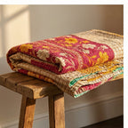 Colorful quilt with floral patterns on a wooden stool