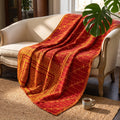A Caravan Story Vintage Cotton Kantha Throw in deep red and golden yellow, adorned with a floral scrollwork border, dashed line grid patterns, and starburst motifs.