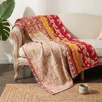 The Wanderer's Tale Vintage Cotton Kantha Throw showcases deep red, mustard yellow, cream, and pink hues, intricately patterned with large floral and vine motifs, small scattered flowers, and striped borders.