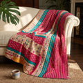 Caravan Meadow Vintage Cotton Kantha Throw featuring fuchsia, teal, beige, and yellow stripes with scattered floral and dot motifs, and visible kantha stitching.
