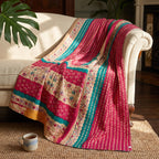 Caravan Meadow Vintage Cotton Kantha Throw featuring fuchsia, teal, beige, and yellow stripes with scattered floral and dot motifs, and visible kantha stitching.