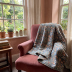 Wild Ginger Bagru Kantha Throw — front draped over a chair in a cosy reading nook
