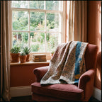 Wild Ginger Bagru Kantha Throw — reverse side draped over a chair in a reading nook