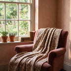 Fireweed Bagru Kantha Throw — reverse side draped over a chair in a reading nook