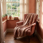 Goldenrod Bagru Kantha Throw — reverse side draped over a chair in a reading nook