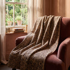 Sweetgrass Bagru Kantha Throw — reverse side draped over a chair in a reading nook
