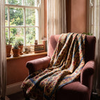 Bearberry Bagru Kantha Throw — front draped over a chair in a cosy reading nook