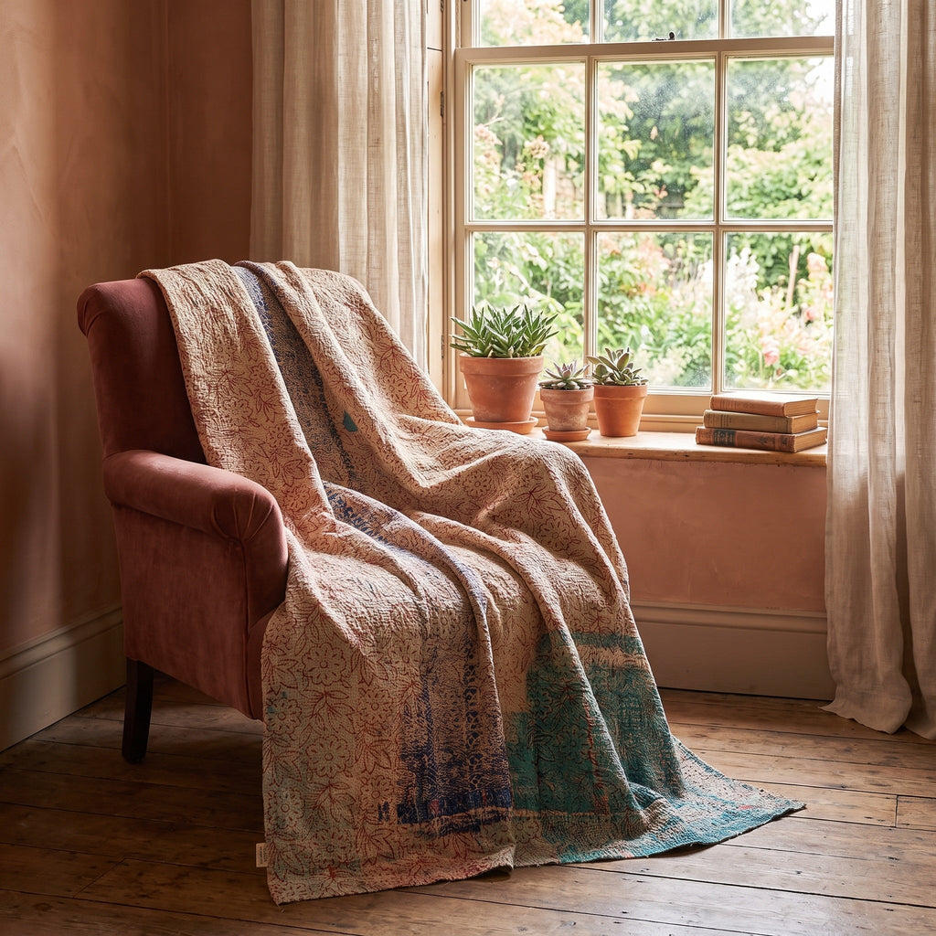 Bearberry Bagru Kantha Throw — reverse side draped over a chair in a reading nook