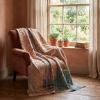 Bearberry Bagru Kantha Throw — reverse side draped over a chair in a reading nook