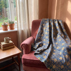 Saskatoon Bagru Kantha Throw — front draped over a chair in a cosy reading nook