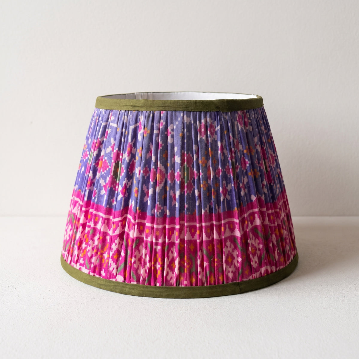 Close view of a handmade pleated lampshade and its fitting