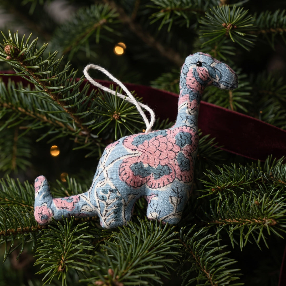 Handcrafted cotton elephant or dinosaur Christmas ornament – Whisper Mist design, hanging on a Christmas tree. Example from random pack of six.