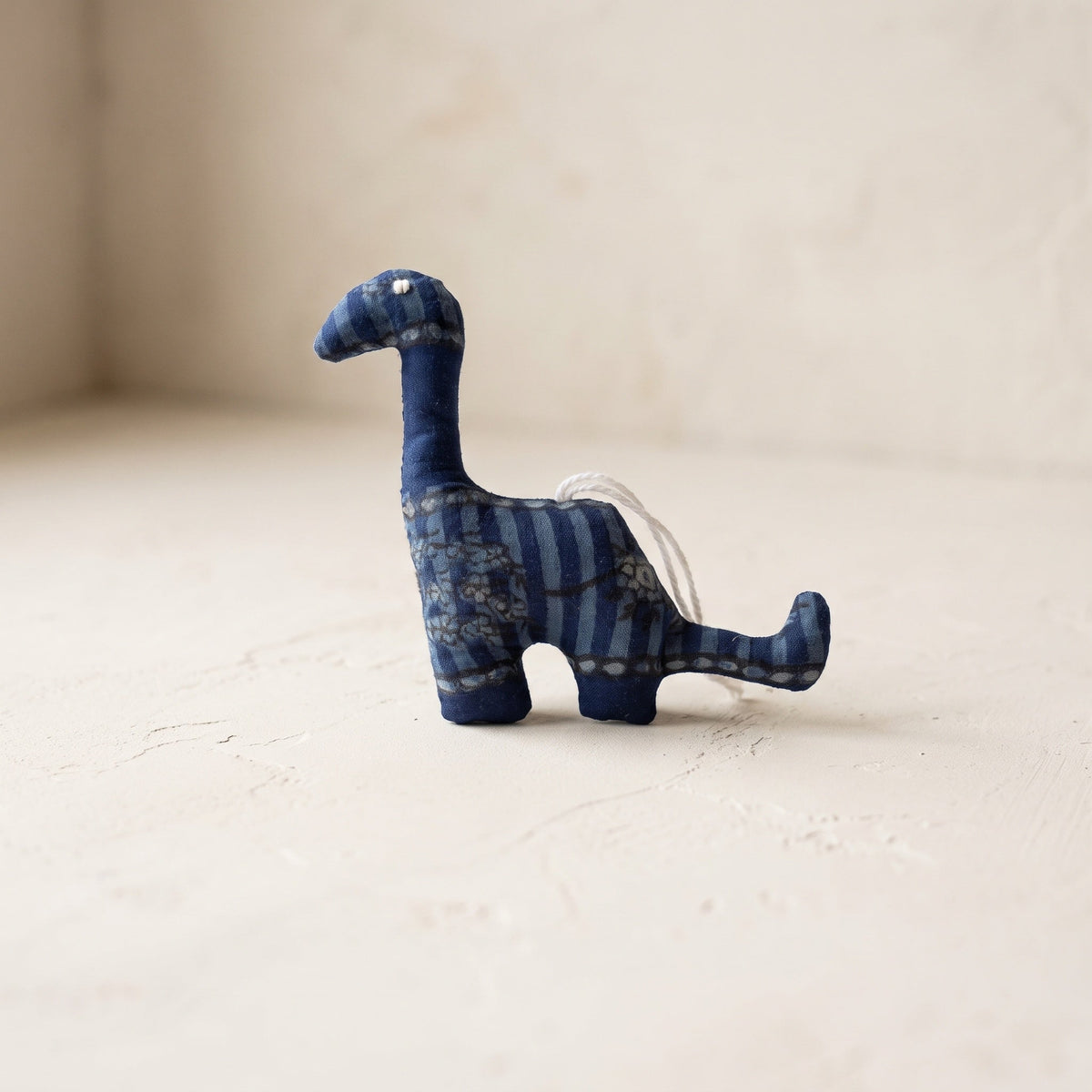 Handcrafted cotton elephant or dinosaur Christmas ornament – Whisper Bloom design, studio hero. Example from random pack of six.