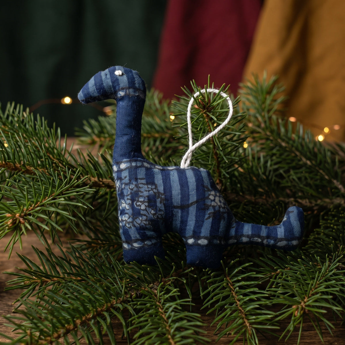 Handcrafted cotton elephant or dinosaur Christmas ornament – Whisper Bloom design, hanging on a Christmas tree. Example from random pack of six.
