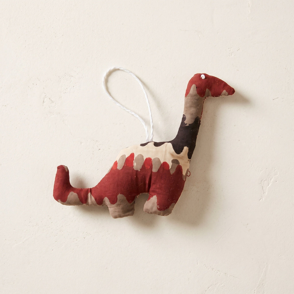 Handcrafted cotton elephant or dinosaur Christmas ornament – Blue Day design, studio hero. Example from random pack of six.
