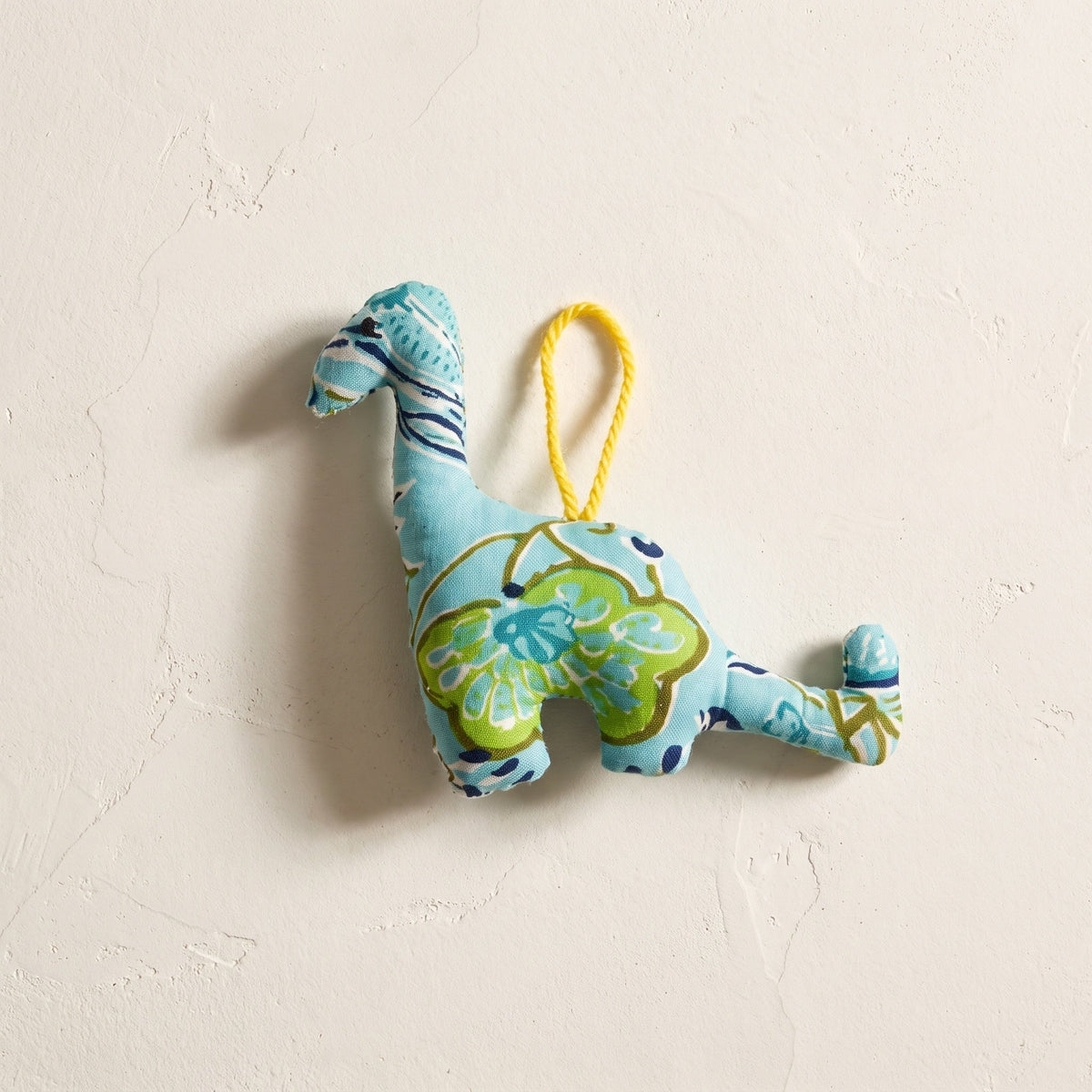 Handcrafted cotton elephant or dinosaur Christmas ornament – Glimmer Amber design, studio hero. Example from random pack of six.