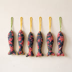 Handcrafted cotton fish Christmas ornament, Whisper Fern design – studio view. Example from surprise pack of six.