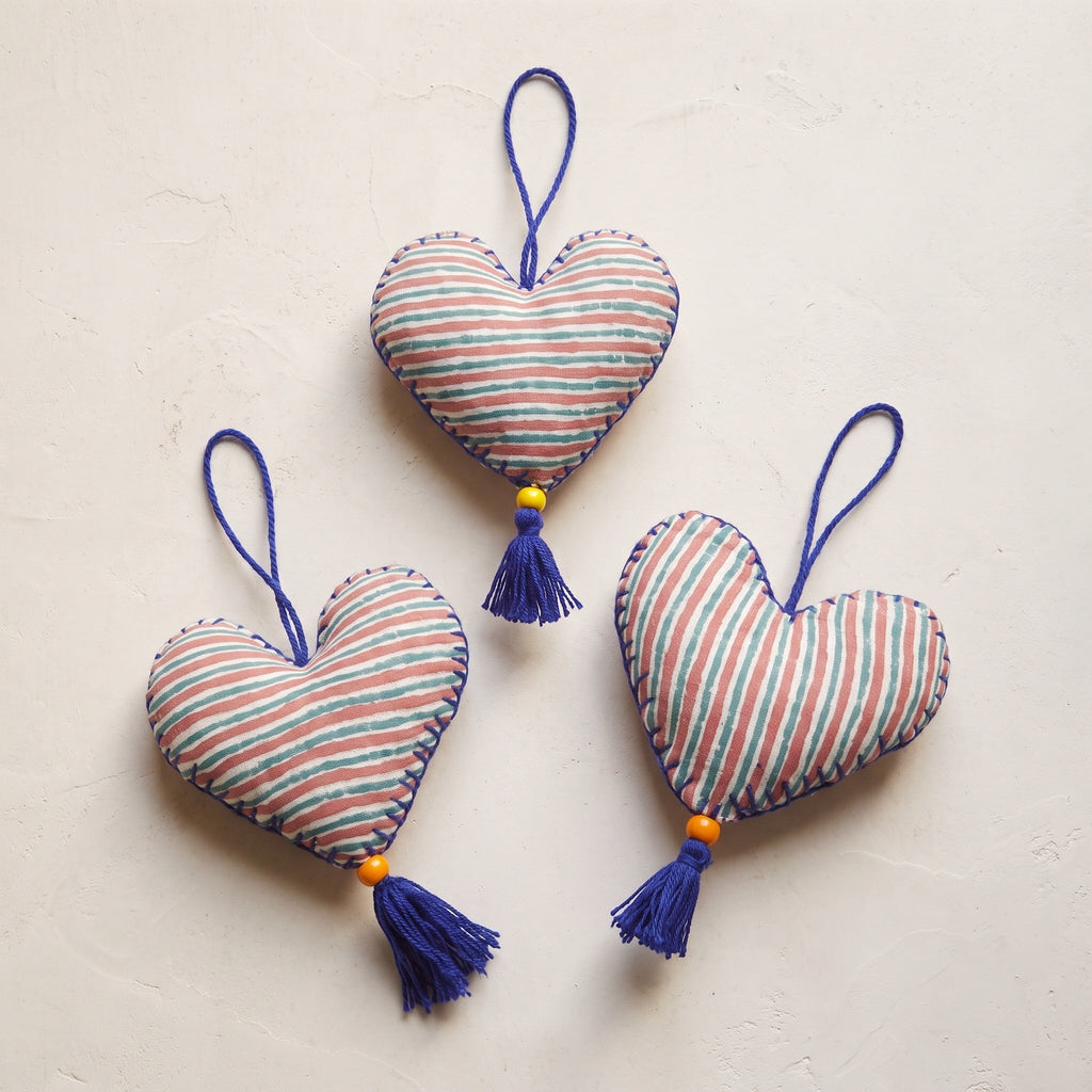 Non-beaded cotton heart Christmas ornament, Sky Fern design – studio view. Example from random assortment of six.