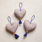 Non-beaded cotton heart Christmas ornament, Sky Fern design – studio view. Example from random assortment of six.