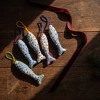 Handcrafted cotton fish Christmas ornament, Clay Dew design – styled photograph. Example from surprise pack of six.
