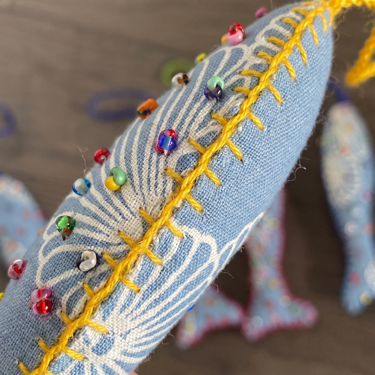 Handcrafted cotton fish Christmas ornament, Clay Dew design – close-up detail. Example from surprise pack of six.