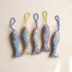 Handcrafted cotton fish Christmas ornament, Clay Dew design – studio view. Example from surprise pack of six.