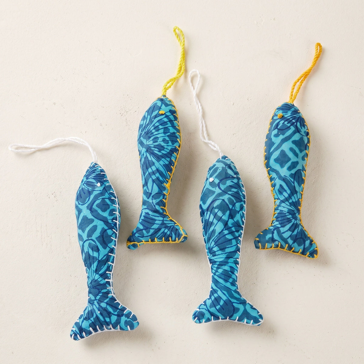 Handcrafted cotton fish Christmas ornament, I Loom design – studio view. Example from surprise pack of six.