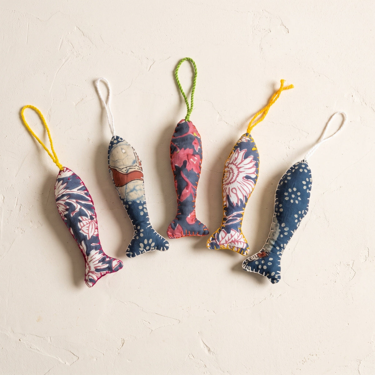 Handcrafted cotton fish Christmas ornament, Verdant Fern design – studio view. Example from surprise pack of six.