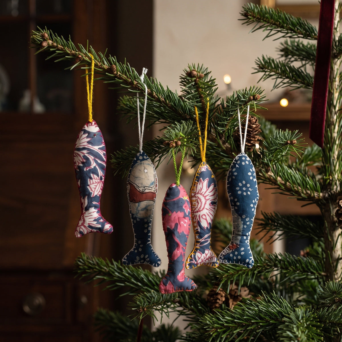 Handcrafted cotton fish Christmas ornament, Verdant Fern design – hanging on a Christmas tree. Example from surprise pack of six.