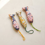 Handcrafted cotton fish Christmas ornament, Terracotta Bloom design – studio view. Example from surprise pack of six.