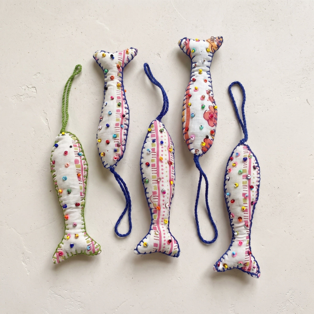 Handcrafted cotton fish Christmas ornament, Whisper Bloom design – studio view. Example from surprise pack of six.