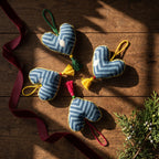 Non-beaded cotton heart Christmas ornament, Mist Tide design – styled flat lay. Example from random assortment of six.