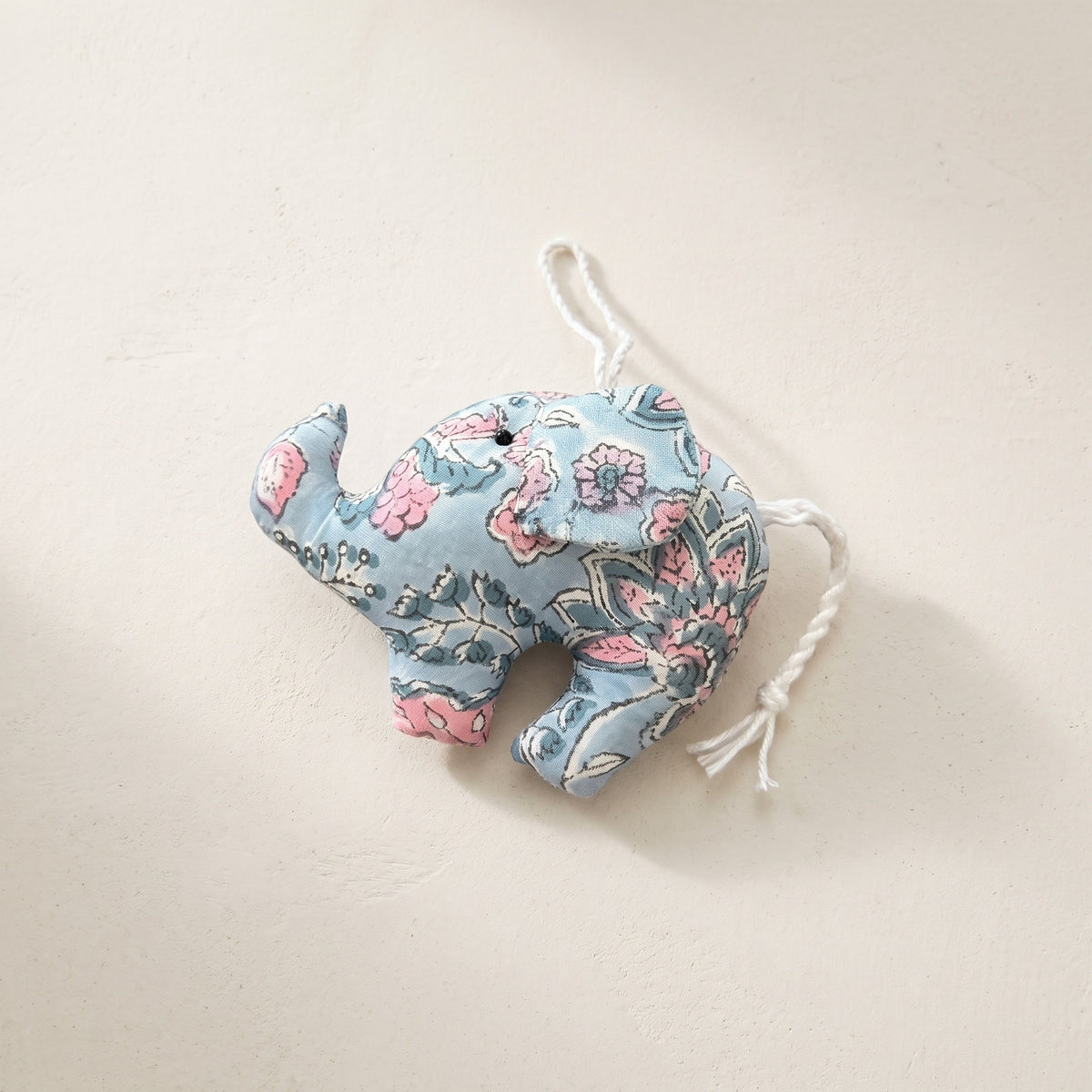 Handcrafted cotton elephant or dinosaur Christmas ornament – Lustre Glow design, studio hero. Example from random pack of six.