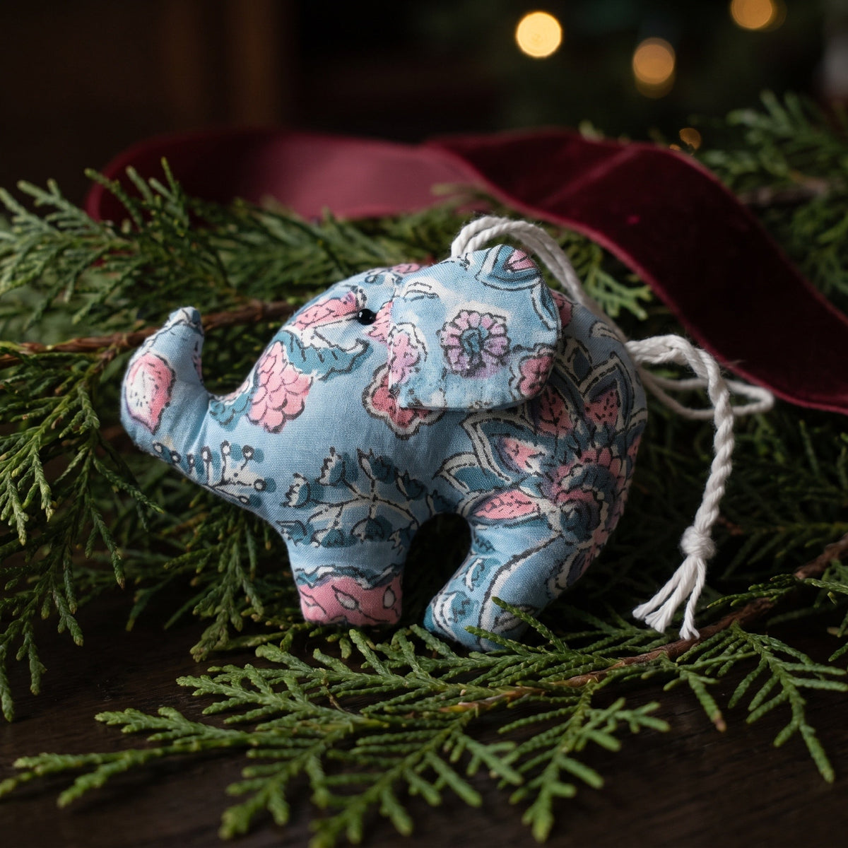 Handcrafted cotton elephant or dinosaur Christmas ornament – Lustre Glow design, hanging on a Christmas tree. Example from random pack of six.