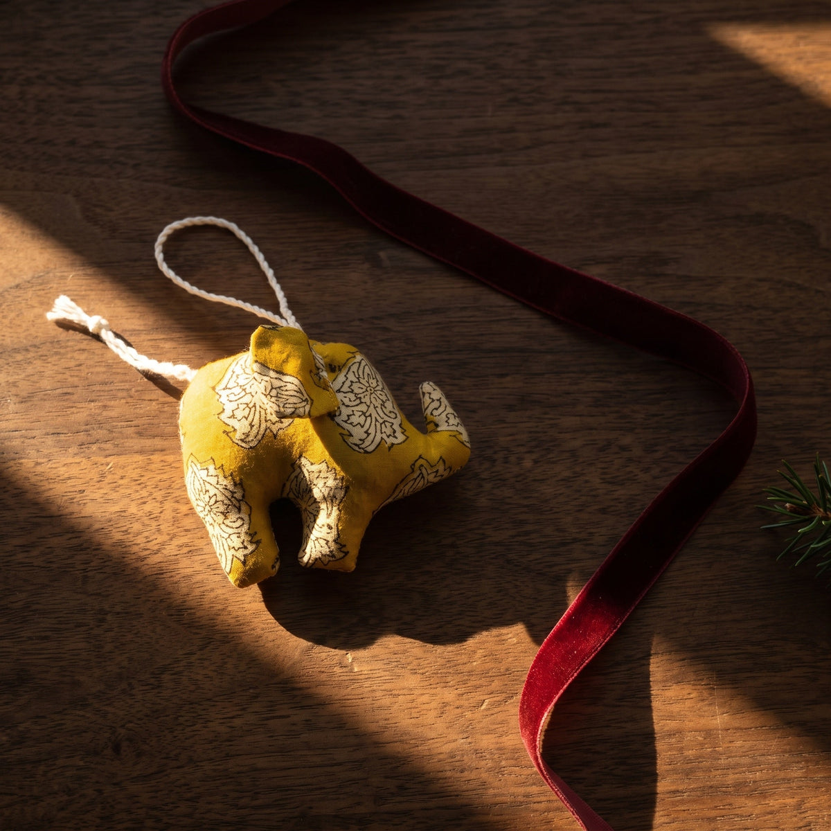 Handcrafted cotton elephant or dinosaur Christmas ornament – Luminous Glow design, styled photo. Example from random pack of six.